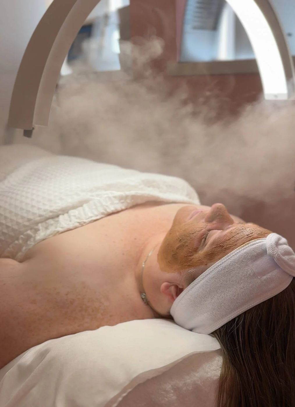 A mask and steam during a facial